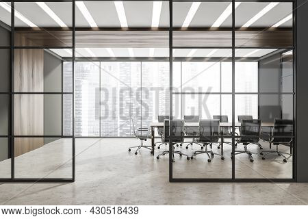 Corridor With Half Empty Panoramic Grey Conference Room Behind The Two Framed Glass Wall Partitions.