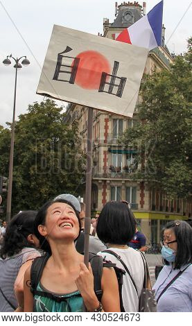 Paris, France - August 21, 2021: A Japanese Activist Of The Anti-macron, Anti-health Passport Policy