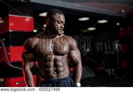 Handsome Strong Bodybuilder With Naked Torso Posing For Camera. Young Sexy Athletic Man Pumping In T