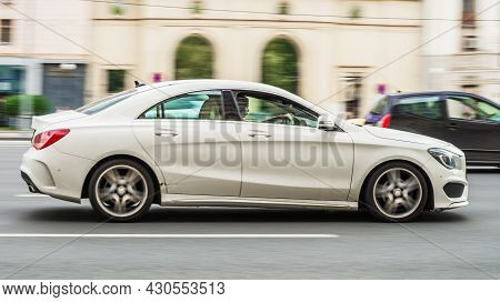 Mercedes Benz Cla Is Accelerating In City Road On Urban Background. Cla-class Is A Series Of Subcomp