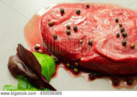 Raw Beef Sirloin Steak With Peppercorns And Garlic Prepared For Frying