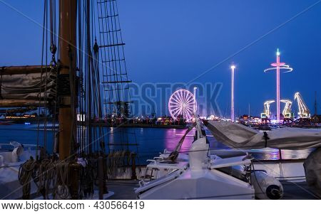 Port City At Night -  Amusement Park And Old Historic Harbor Cranes In The Area Of 
