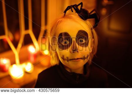 Little Child In Scary Skeleton Costume At Halloween Celebration Party. The Child Is Ready For Trick 