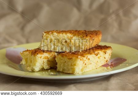 Pieces Of Baked Mannik Semolina Casserole On Yellow Plate