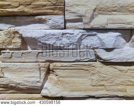 Background Of Masonry Of White And Yellow Stones Arranged Horizontally In The Rays Of The Sun