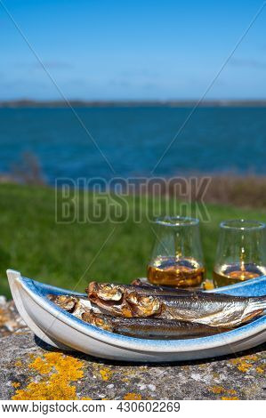 Smoked Sprattus Or Sprats Sea Fish Served Outdoor With View On Blue Sea Water