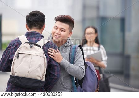 Positive You Man Greeting His Best Friend After Summer Vacation When Standing On College Campus