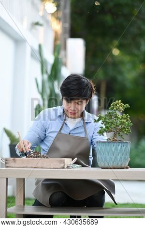 Portrait Of Young Man Taking Care Of Plants As A Hobby Of Home.