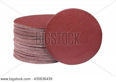 Red Round Sandpaper Disc Stands Vertically Next To The Sander Disc Stack. Sanding Disc For Sander Gr
