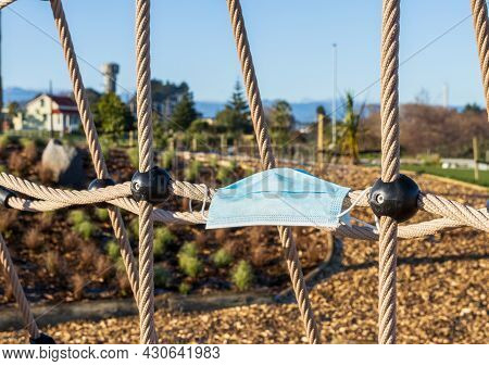 Covert-19 Face Mask On A Playground Climbing Ropes Symbolising We All Need To  Do Our Part To Climb 