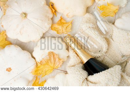 Cozy Still Life For Winter And Autumn Holiday With Wine Glasses, Bottle, White Squash Pumpkin, Wolle