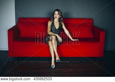Gorgeous Attractive Brunette Woman With Evening Make-up And Ruby Lips In Beautiful Sequin Dress Sitt