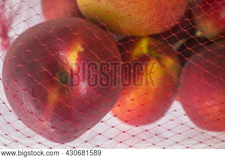 Nectarines On Their Plastic Package Covered. Closeup