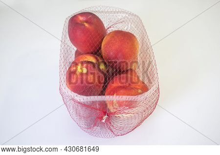 Nectarines On Their Plastic Package Covered. Closeup