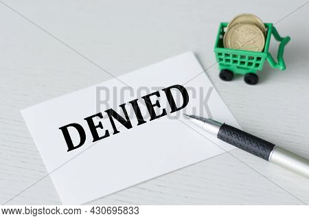Card With The Text Denied On A White Background Next To The Handle And Carzine With Manets, Business