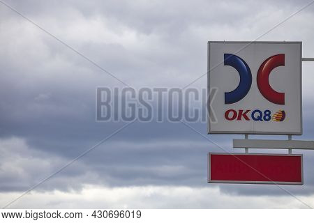 Close Up View Of Logotype Board Of Well-known Gas Station Okq8 On Cloudy Sky Background. Sweden. Eur