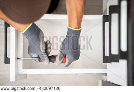 Professional Cabinetmaker Finishing Kitchen Cabinet Drawers Installation. Top View Close Up. Home Im