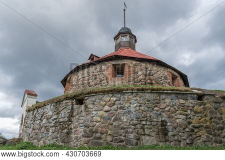 At The Foot Of The Ancient Lars Torstensson Tower (pugachev Tower) On A Cloudy August Day. Fortress 