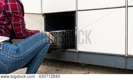 Automated Locker. Parcel Courier Box In Woman Hands At Post Delivery Automat Terminal. Courier Puts 