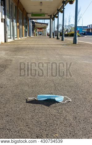 Covert-19 Face Mask Left At A Empty Town Main Street Because Of Covert-19 Lockdown.