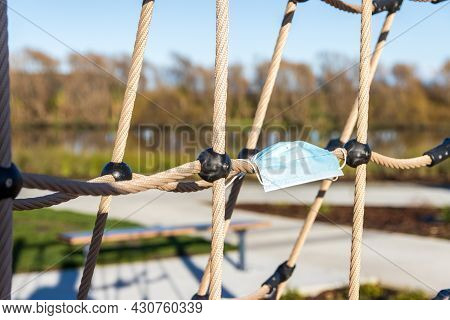 Covert-19 Face Mask On A Playground Climbing Ropes Symbolising We All Need To  Do Our Part To Climb 