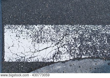 Zebra Crossway With Some Faded On Asphalt Road Close-up View.background For Safety First Or Transpor