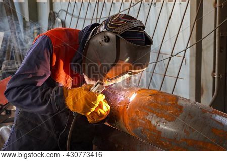 A Professional Welder Welds A Pipe With A Diameter Of Dn250 For A Process Pipeline And Corrects Defe