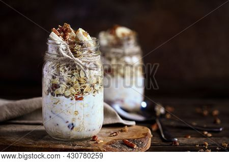 Healthy Overnight Oatmeal, Bircher Muesli, Served With Bananas, Brown Sugar, Pecan Nuts, And Maple S