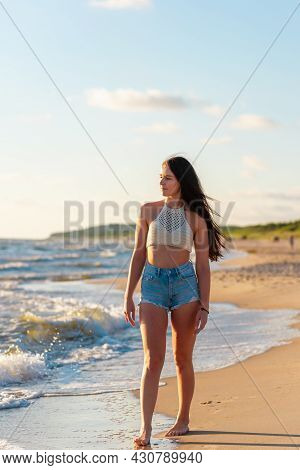 Lonely Young Woman Walking On The Beachsunset Day.beach Woman In Fashion Beachwear Relaxing Walking 