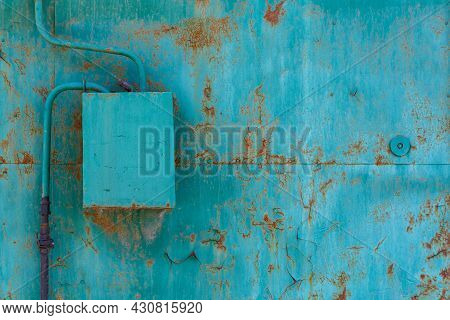 Turquoise Painted Cracked And Rusted Flat Steel Sheet With Natural Gas Meter And Distributor Box