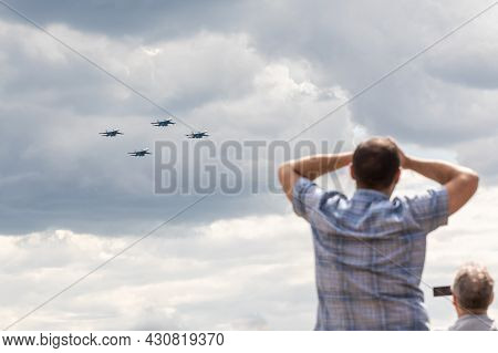 25.07.2021, Russia, Zhukovsky. Spectators Look Into The Sky Behind Military Aircraft Fighters Perfor