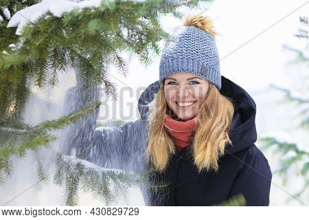 Portrait Beautiful Happy Girl Whitework Smile Teeth, Blue Eyes Playing With Snow On Spruce Backgroun