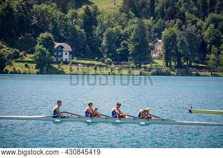 Bled, Slovenia - June 13, 2021: Four Young Male Adults, Rowers, On A Coxed Four, A Rowing Boat, Trai