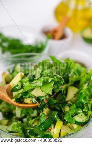 Woman Mix Salad Of Fresh Green Vegetables And Herbs. Raw Food Concept. Vegan Menu. Cooking Healthy D