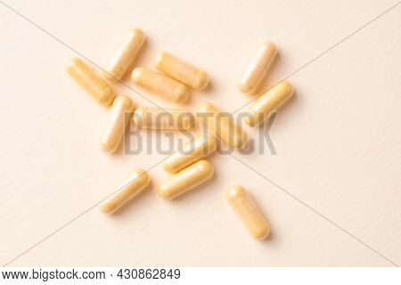 Coenzyme Q10 Capsules. Dietary Supplements. Bright Paper Background. Top View. Copy Space.
