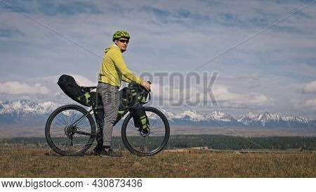 The Man Travel On Mixed Terrain Cycle Touring With Bikepacking. The Traveler Journey With Bicycle Ba