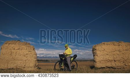 The Man Travel On Mixed Terrain Cycle Touring With Bikepacking. The Traveler Journey With Bicycle Ba