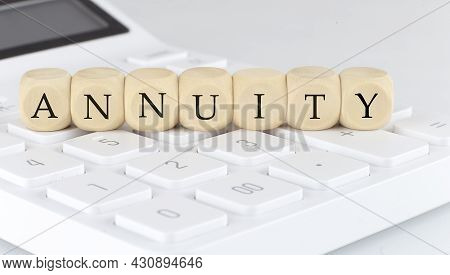 Wooden Cubes With Text Annuity On The Calculator, Business