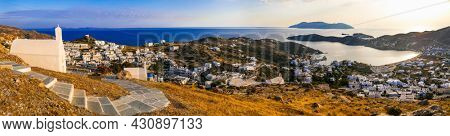 Breathtaking panoramic sunset view of Ios island. Chora town with churches and whitwashed houses. Popular tourist destination in Cyclades, Greece