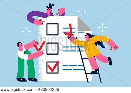 Time Management And Task Completion Concept. Group Of Business People Standing Around Huge List Of W