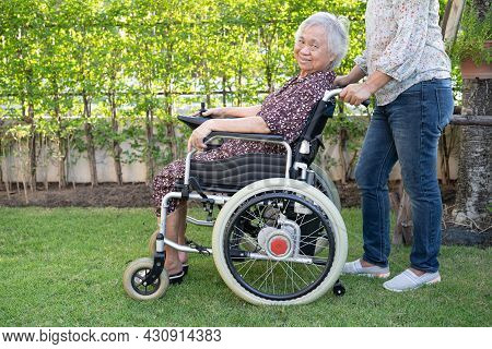 Doctor Help And Care Asian Senior Or Elderly Old Lady Woman Patient Sitting On Wheelchair At Park In