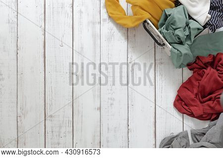 A Pile Of Clothes On A Wooden Floor, The Concept Of Washing And Cleaning, Chaos And Mess In Things, 