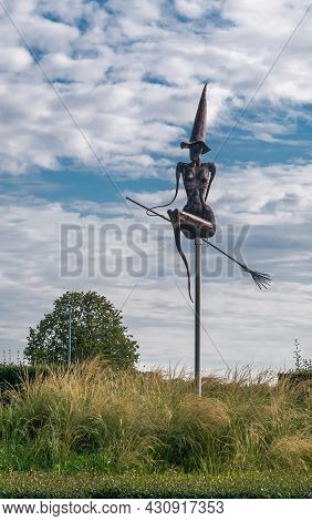 Zonnebeke, Belgium - August 2, 2021: Black Metal Witch On Broom Statue In Middle Of Roundabout Off A