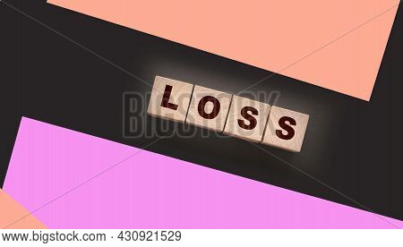 Wooden Cubes With Loss Word On Blacktable. Financial Loss Busines Concept