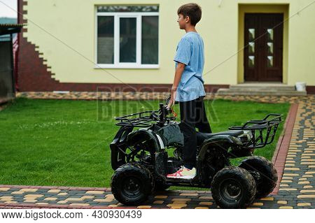 Boy In Four-wheller Atv Quad Bike.