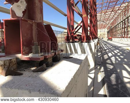 Metal Pillar Fastened To Basement With Anchor Bolts And Nuts. Supporting Structures, Metal Frame Of 