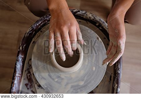 Woman Hands Working On Pottery Wheel And Making A Pot. Young Woman Making Pottery On The Wheel. Scul