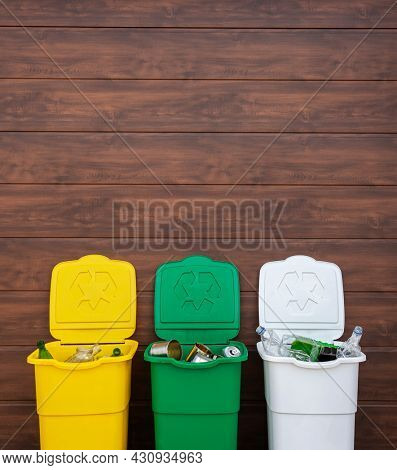 Three full dustbins for sorting trash on the backyard