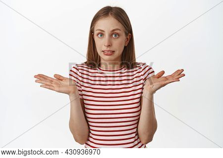 I Dont Know, Nothing To Say. Young Awkward Blond Girl, Shrugging Shoulders And Spread Empty Hands Si