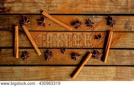 CINNAMON STICKS ON WOODEN BACKGROUND
